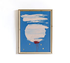 May include: Abstract art print in a gold frame. The artwork features a large white circle with brushstrokes, a blue background, and red paint drips. Gold dots are scattered around the circle. The frame is a light gold color.
