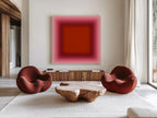 May include: A modern living room featuring two rounded, rust-colored armchairs and a unique wooden coffee table. A large abstract painting with a gradient of pink and red hues hangs above a wooden cabinet. The room is decorated with a neutral-toned rug.