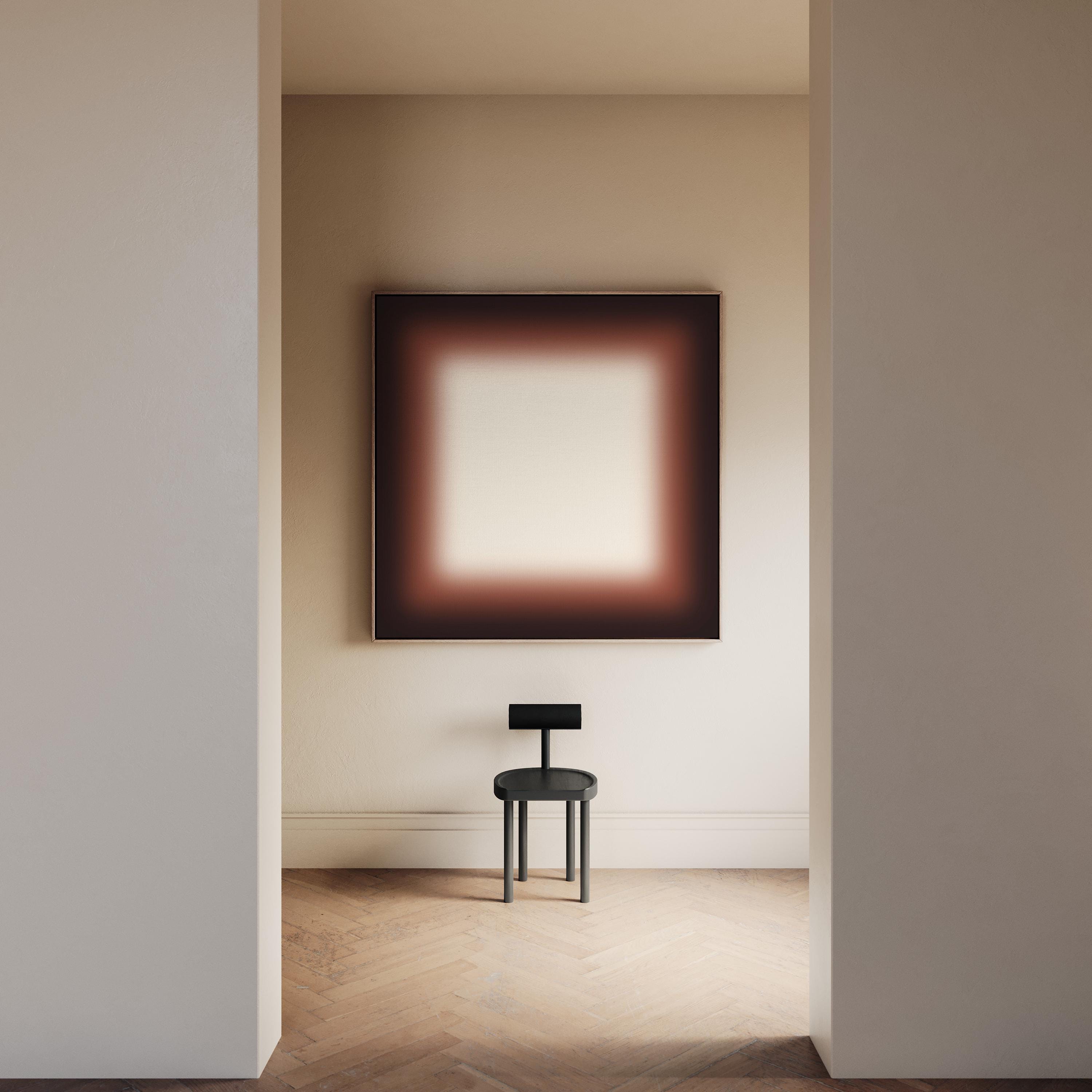 May include: An interior shot featuring a minimalist aesthetic. A black chair sits on a wooden floor beneath a large abstract painting with a brown and white gradient. The room is framed by neutral-colored walls and doorways.