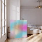 May include: A large square canvas with a soft, colorful gradient of pink, blue, and yellow hues. The text "everything comes when it's time" is written in white. The canvas is propped up in a bright, modern room.