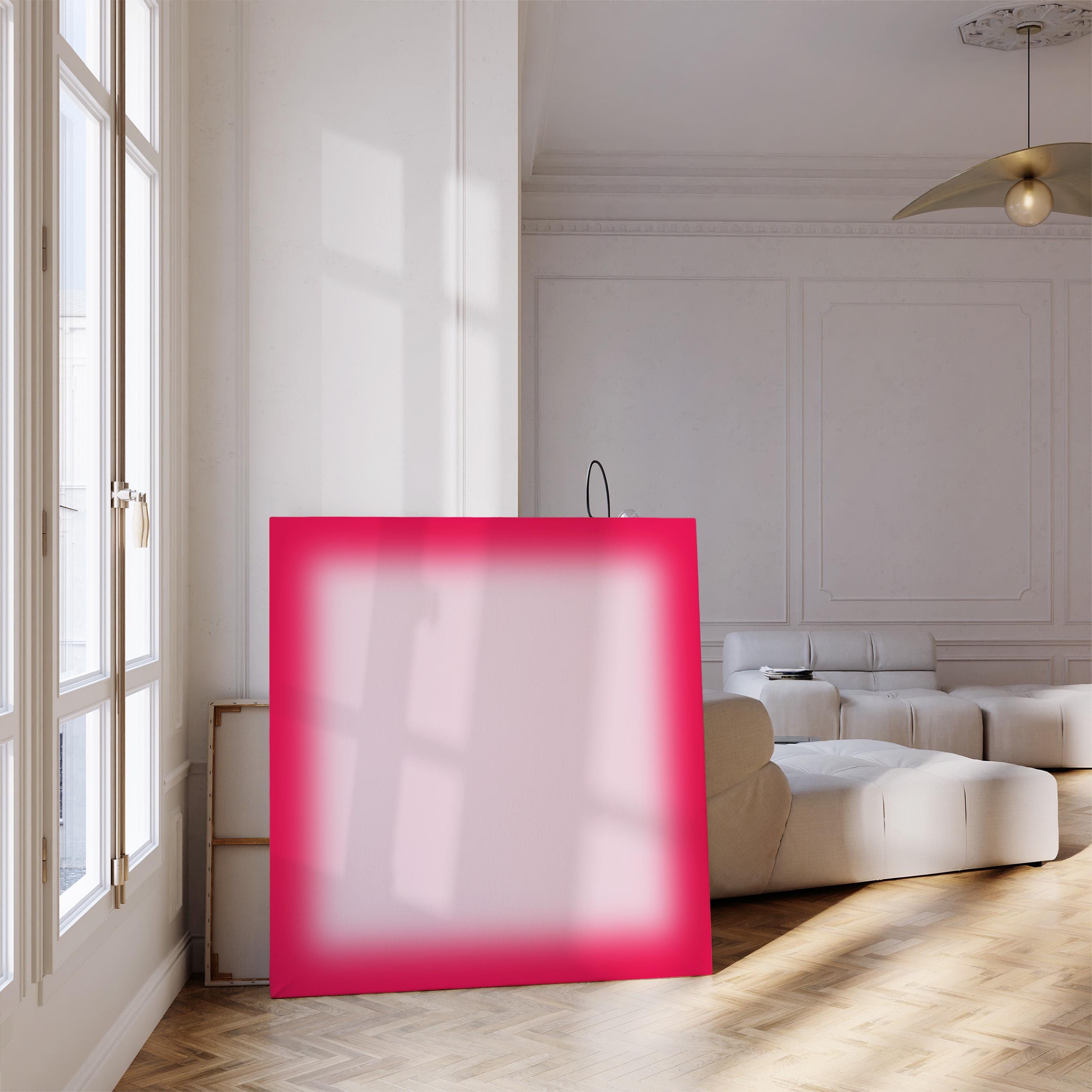 May include: A large, vibrant pink square canvas leans against a wall in a well-lit room. The canvas has a soft, blurred center and a bright pink border. The room features a white sofa, wooden floors, and a large window.