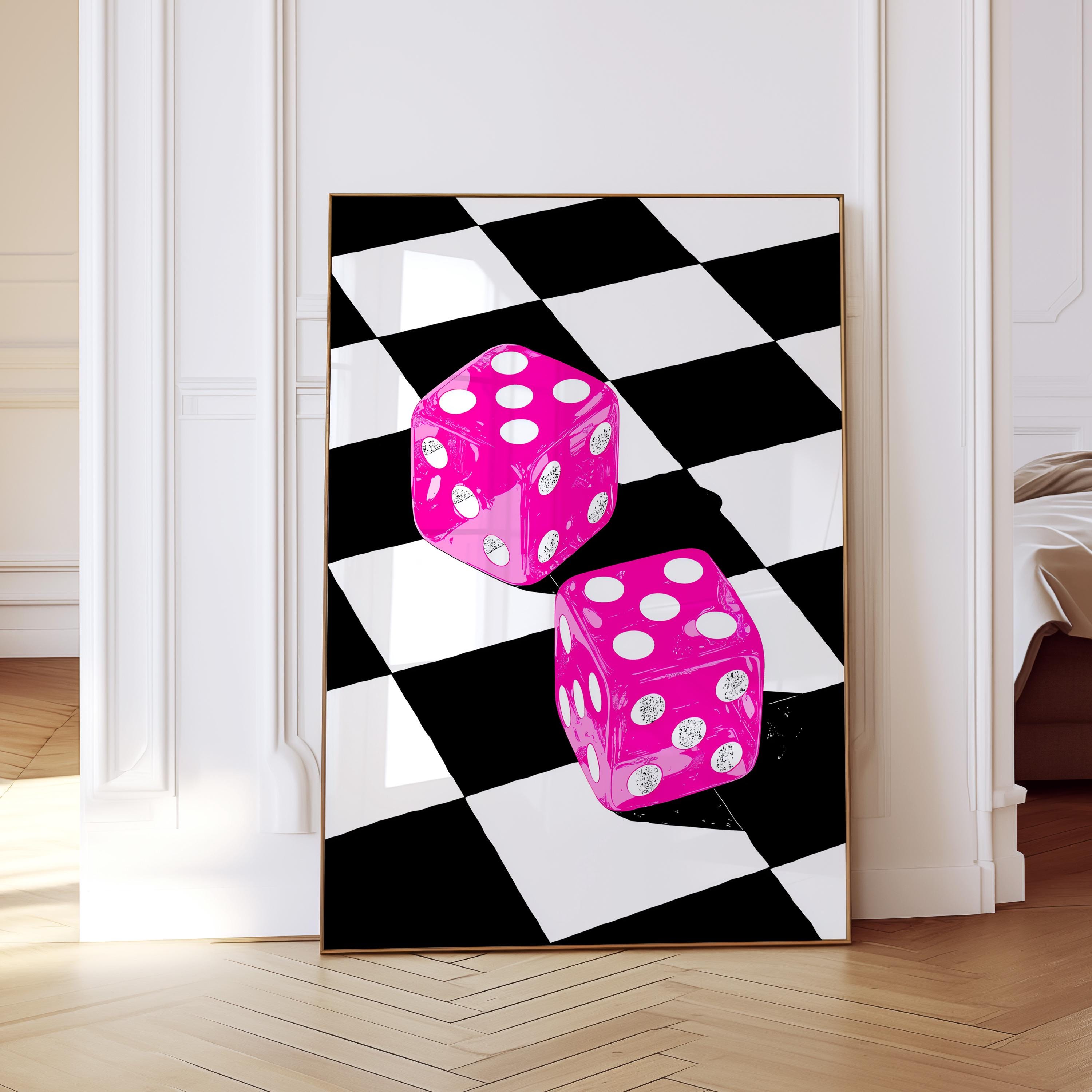 May include: A framed art print featuring two oversized, bright pink dice with white dots, set against a black and white checkered background. The dice appear to be floating, creating a playful and modern aesthetic.