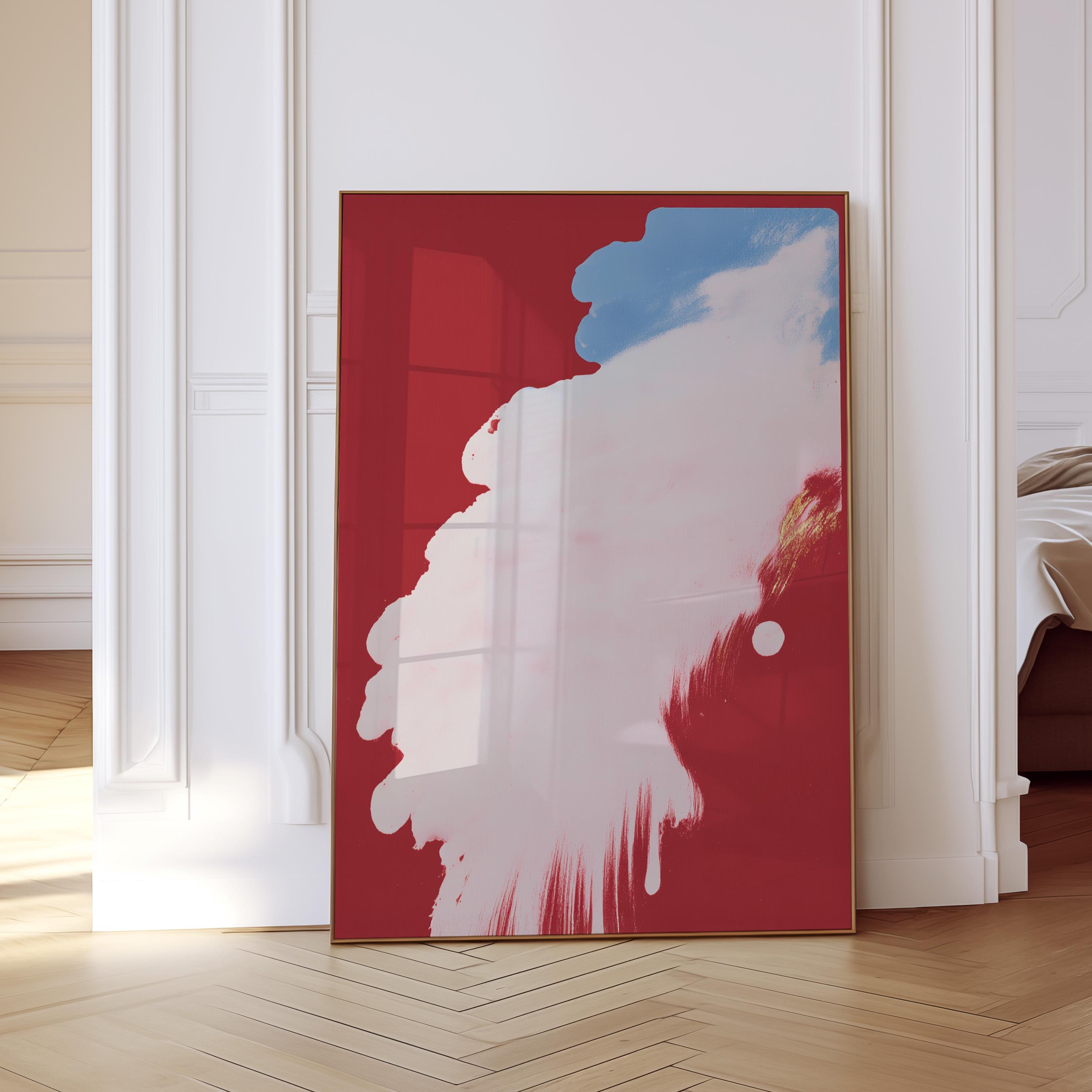 May include: A framed abstract art print featuring a bold red background with a large white and blue cloud-like shape. The artwork has a modern aesthetic and is displayed in a room with white walls and a wooden floor.