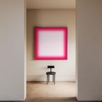 May include: A modern interior scene featuring a large square artwork with a vibrant pink gradient border and a white center. A small black chair sits below the artwork. The room has light-colored walls and a wooden floor.