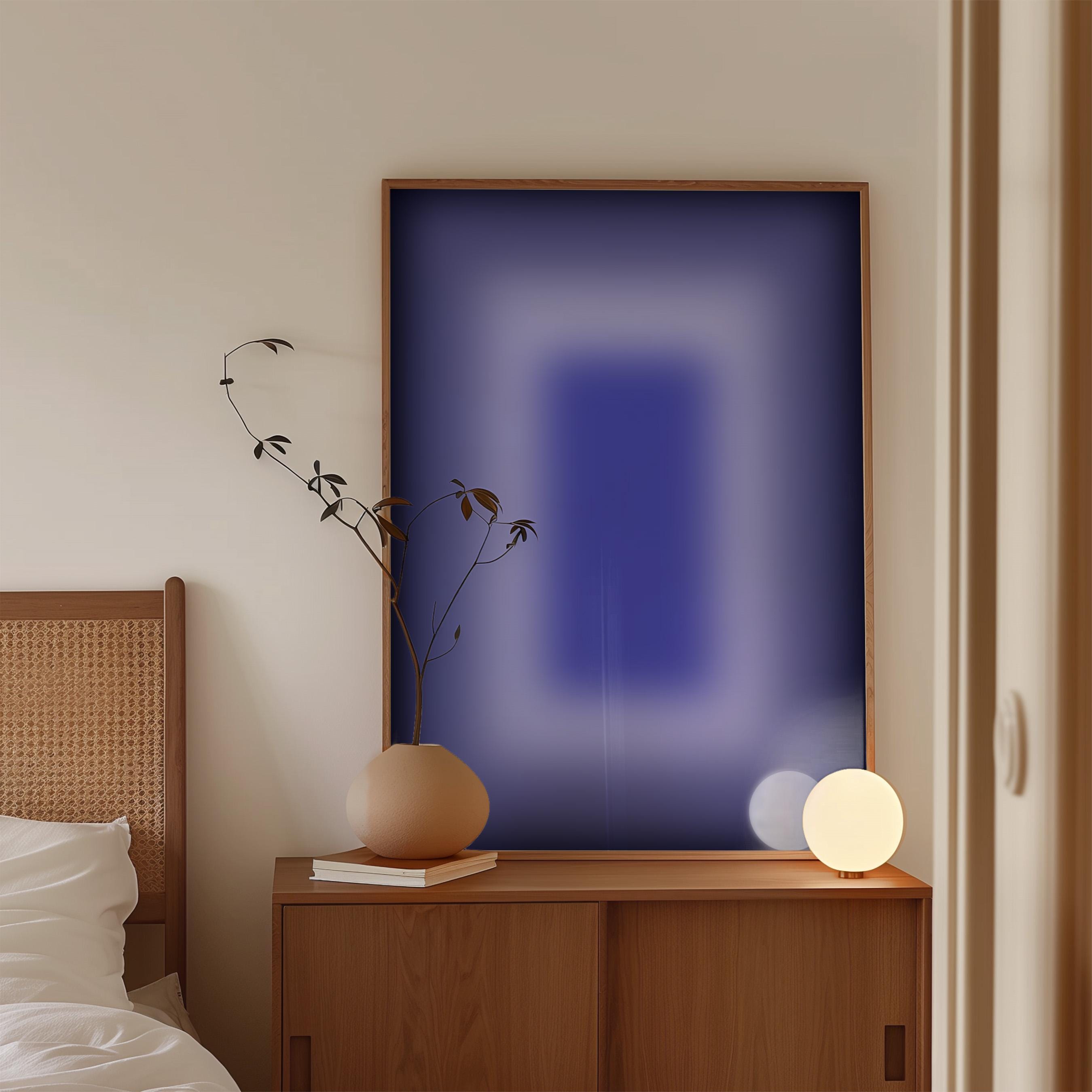 May include: A modern bedroom scene featuring a wooden cabinet with a framed abstract art piece in shades of blue. A beige vase with a plant and a spherical lamp sit on the cabinet. A bed with a woven headboard is partially visible.