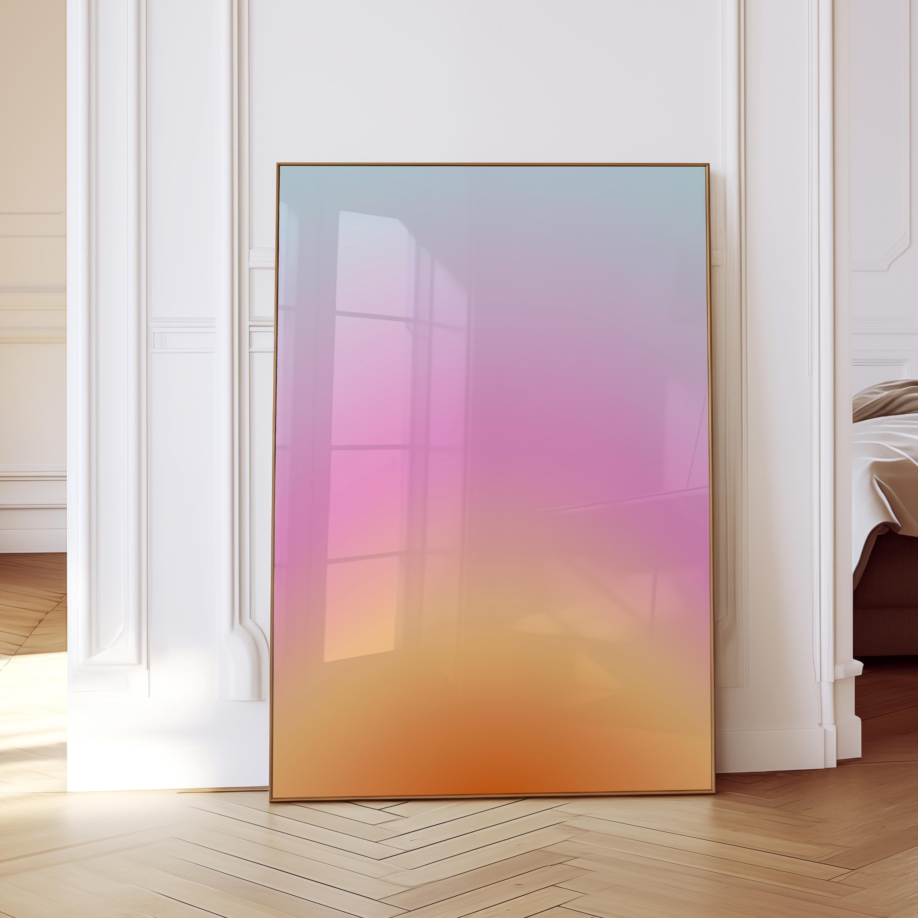 May include: A framed art print with a gradient of colors, transitioning from light blue at the top to pink in the middle, and finally to orange at the bottom. The artwork is displayed in a room with white walls and a wooden floor.