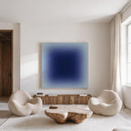 a modern living room with a large blue square artwork hanging on the wall. The room is furnished with two white armchairs and a wooden coffee table, creating a cozy and inviting atmosphere.