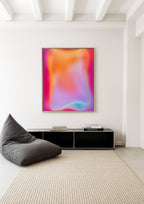 May include: A modern living room setup featuring a large abstract art piece with a vibrant gradient of pink, orange, and blue hues. A dark gray beanbag chair sits next to a black cabinet, and a beige rug covers the floor.