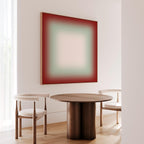 a modern dining area with a wooden table and two white chairs. Above the table, there is a large abstract painting in red and green colors. The room has a minimalist and clean design, with white walls and a wooden floor.