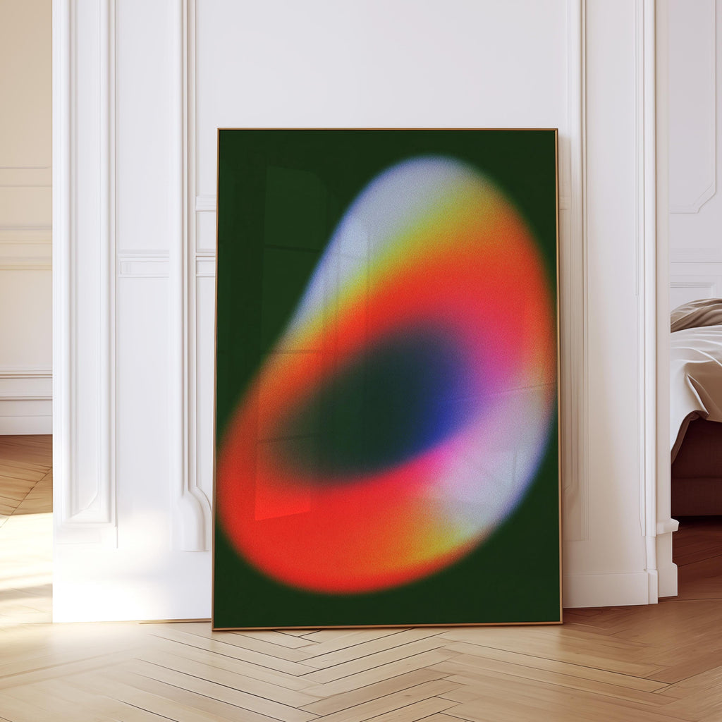 May include: A framed abstract art print featuring a vibrant, blurred design. The artwork showcases a gradient of colors, including red, orange, yellow, and blue, set against a dark green background. The print is displayed in a room with white walls and a wooden floor.