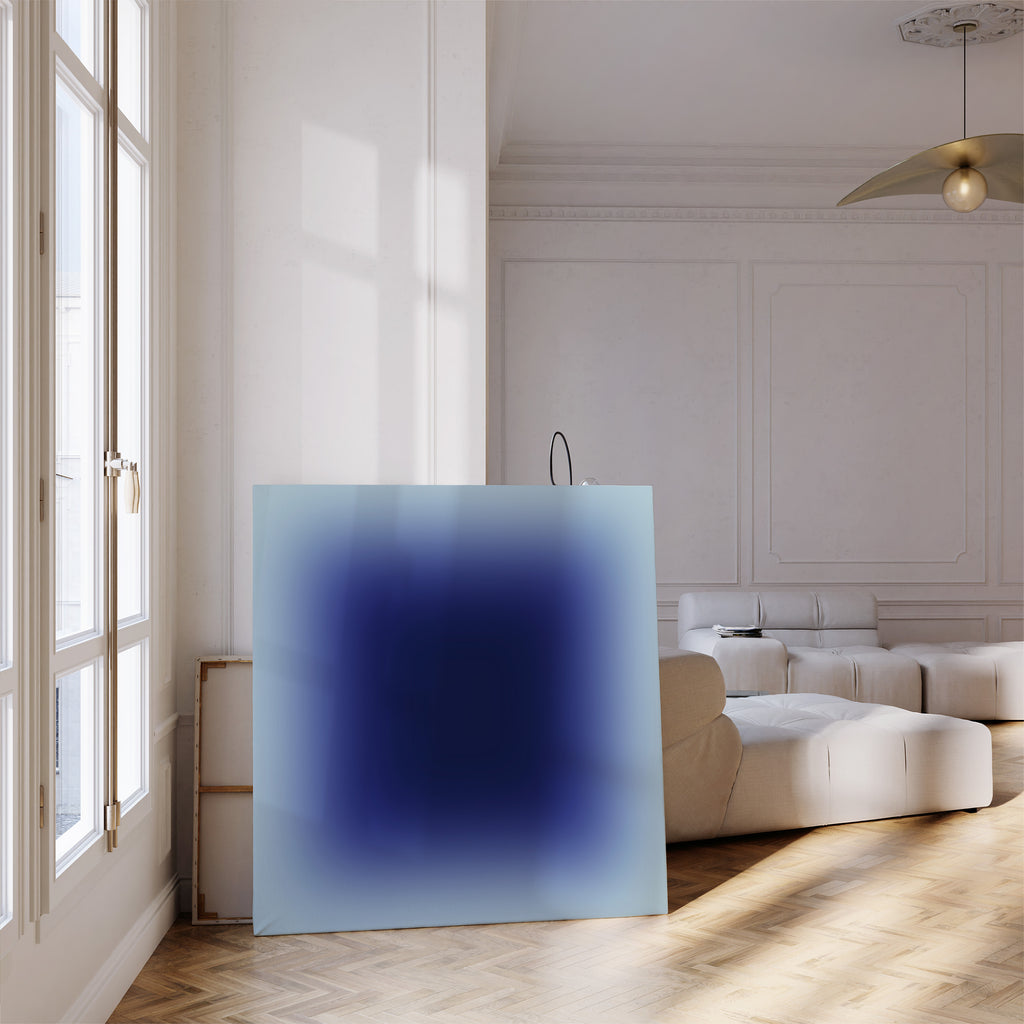 Minimal blue gradient wall art print with deep navy center and soft sky edges, displayed in a modern interior.