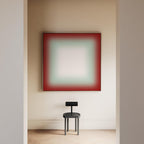 a minimalist interior design with a large red square artwork hanging on a white wall, and a black chair positioned in front of it.