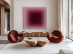 May include: A modern living room featuring two red armchairs, a wooden coffee table, and a large abstract painting with a gradient of pink and burgundy hues. The room has a neutral color palette with a white rug and wooden furniture.
