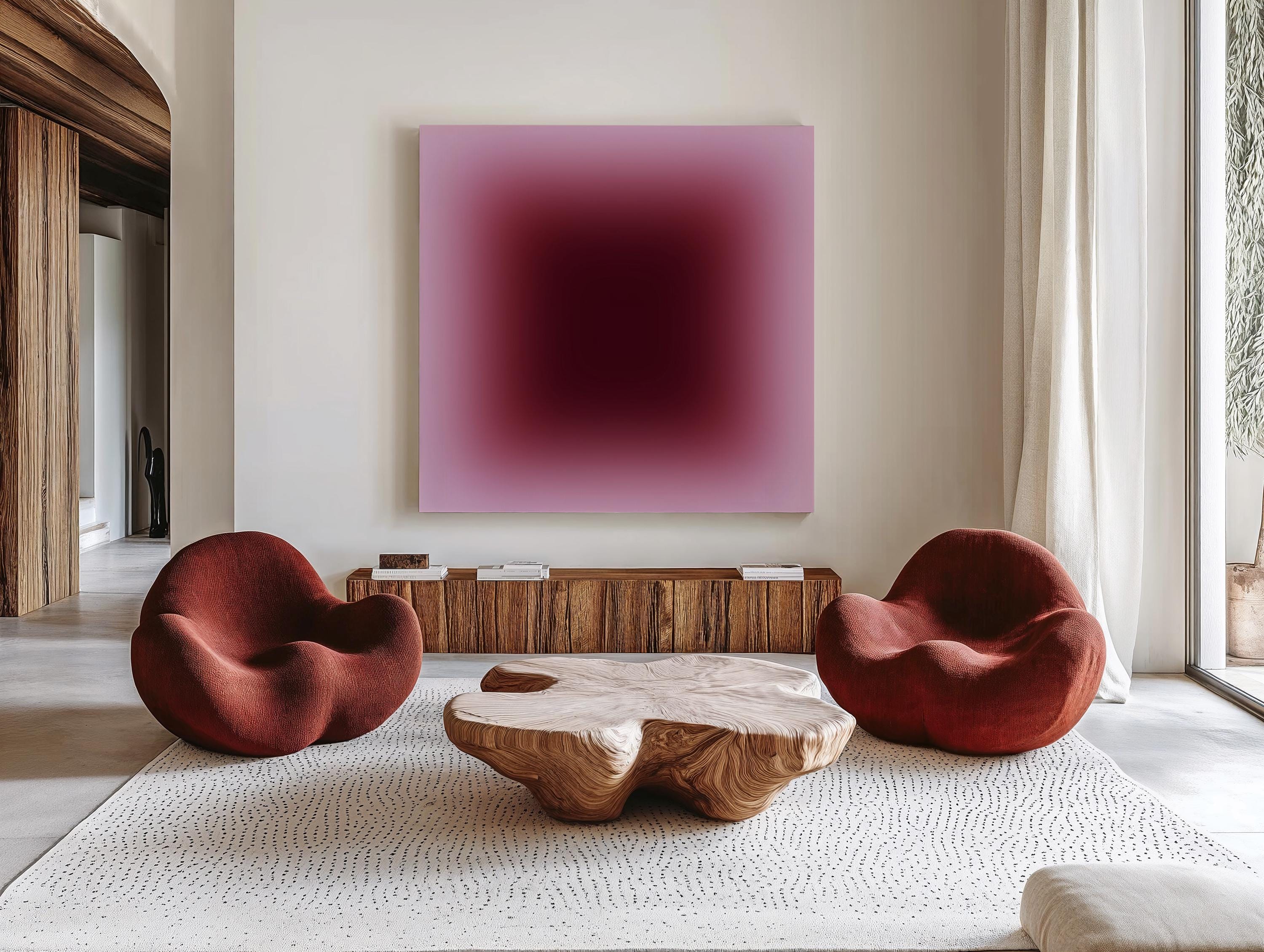 May include: A modern living room featuring two red armchairs, a wooden coffee table, and a large abstract painting with a gradient of pink and burgundy hues. The room has a neutral color palette with a white rug and wooden furniture.