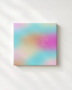 May include: A square canvas art piece with a soft, blurred background of pastel colors: turquoise, pink, orange, and yellow. The text "everything comes when it's time" is printed in a delicate, light font.