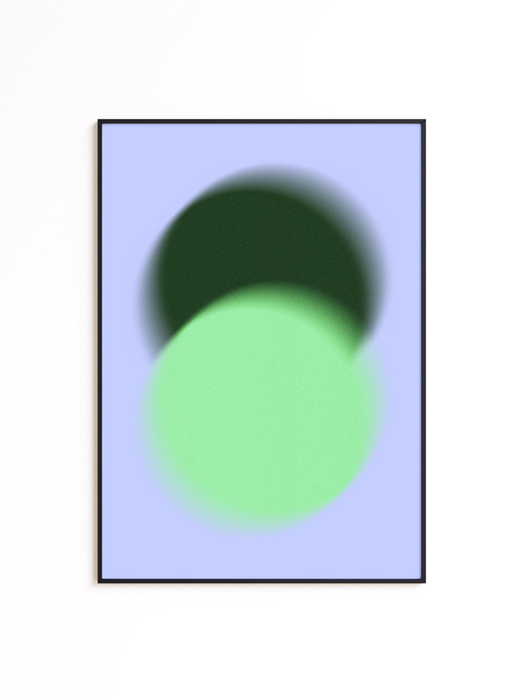 May include: Abstract art print featuring two overlapping blurred circles. The top circle is dark green, and the bottom circle is light green, set against a pale blue background. The artwork is framed in a black border.
