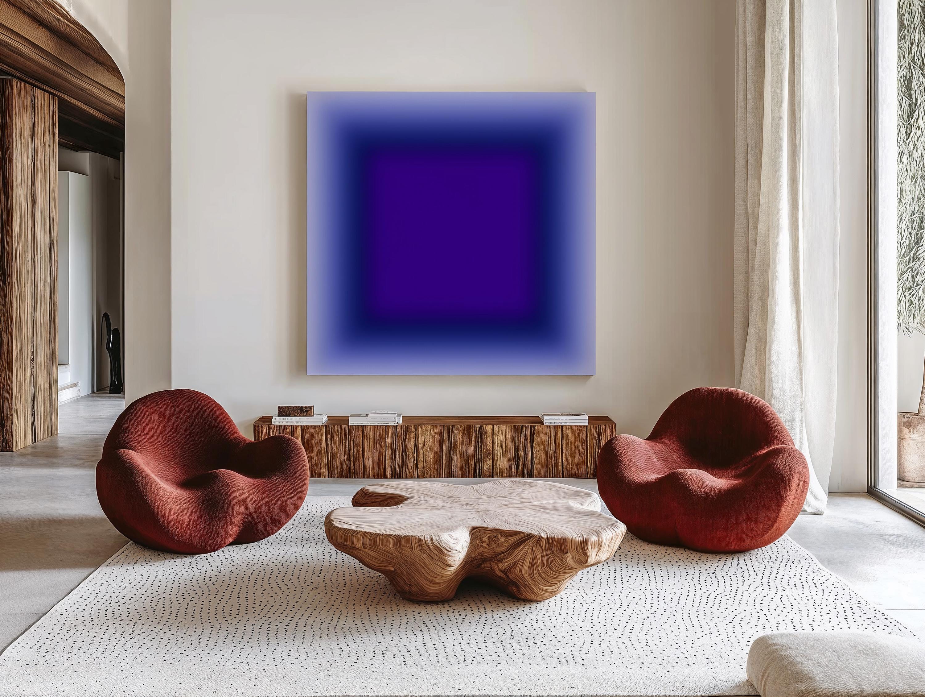 May include: A modern living room featuring a large abstract painting with a gradient of blue and purple hues. Two rounded, rust-colored chairs face a unique wooden coffee table. A wooden cabinet and a patterned rug complete the contemporary design.