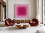 May include: A modern living room featuring a large abstract painting with a gradient of pink and magenta hues. Two rounded, rust-colored armchairs flank a unique wooden coffee table. The room is decorated with a neutral rug and wooden furniture.