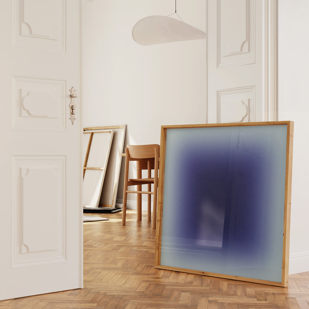 Blue gradient minimalist wall print styled in a modern room with wooden floor and bright atmosphere.